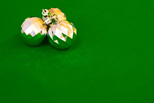 Christmas decoration silver or gold on green tablecloth or cloth