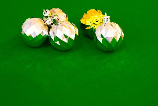 Christmas decoration silver or gold on green tablecloth or cloth