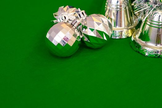 Christmas decoration silver or gold on green tablecloth or cloth