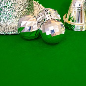 Christmas decoration silver or gold on green tablecloth or cloth