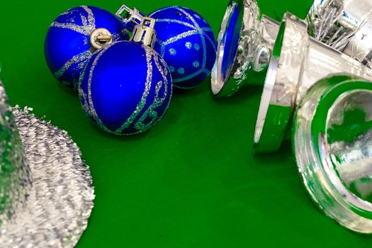 Christmas decoration silver or gold on green tablecloth or cloth