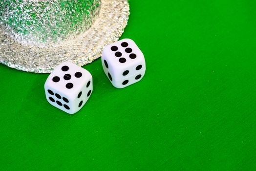 white dice on green cloth or tablecloth