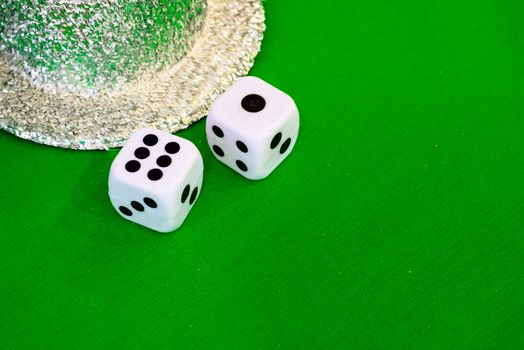 white dice on green cloth or tablecloth