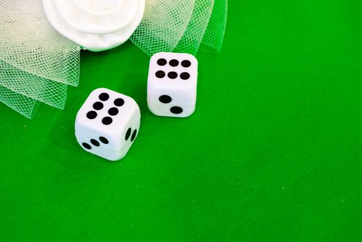 white dice on green cloth or tablecloth