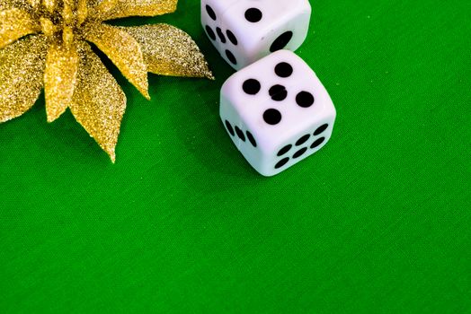 white dice on green cloth or tablecloth