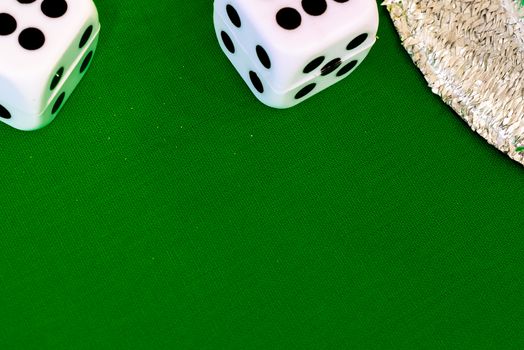 white dice on green cloth or tablecloth