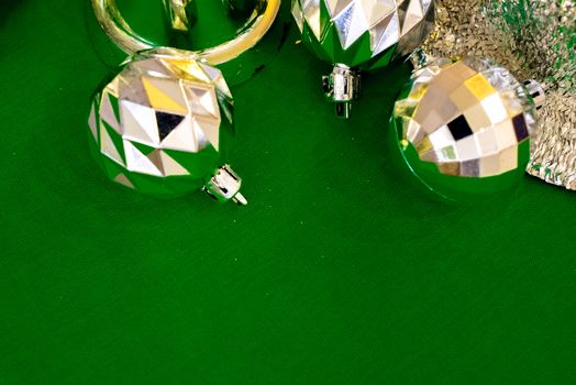 Christmas decoration silver or gold on green tablecloth or cloth