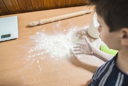 Making bread in a kitchen. Child make bread. Balls of dough