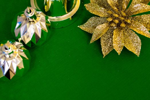 Christmas decoration silver or gold on green tablecloth or cloth