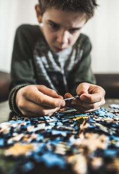 Child and puzzle. Pile puzzles