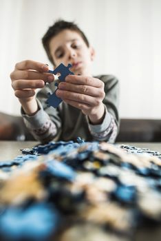 Child and puzzle. Pile puzzles