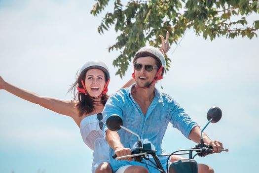 Happy couple on a scooter at summer vacation