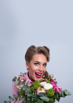 Woman in pink clothes surprised with bunch of flowers for Valentines day, funny emotional expression