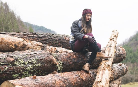 Young woman on wood logs