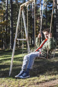 Child on a swing in a forest