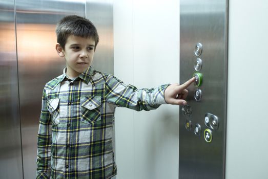 Child pushed a button in an elevator.