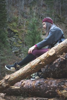 Young woman on wood logs