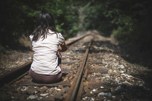Women sitting on railroad