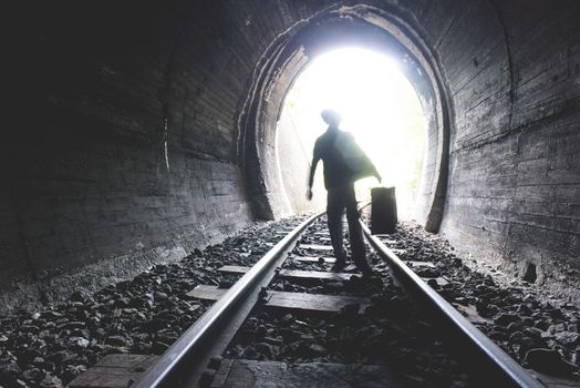 Child walking in railway tunnel. Vintage clothes