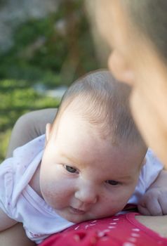 Baby in his mother's arms. Close up