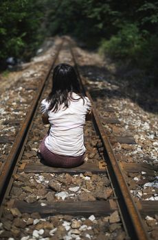 Women sitting on railroad