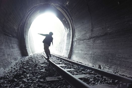 Child walking in railway tunnel. Vintage clothes