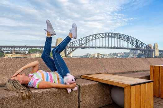 Happy tourist or visitor at Circular Quay with backdrop of Sydney Harbour Bridge