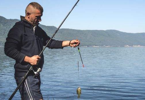 Fisherman caught a fish in mountain dam