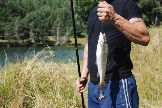 Fisherman caught a fish in mountain dam