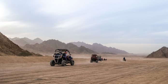 the trip of tourists to the desert by buggy in Egypt