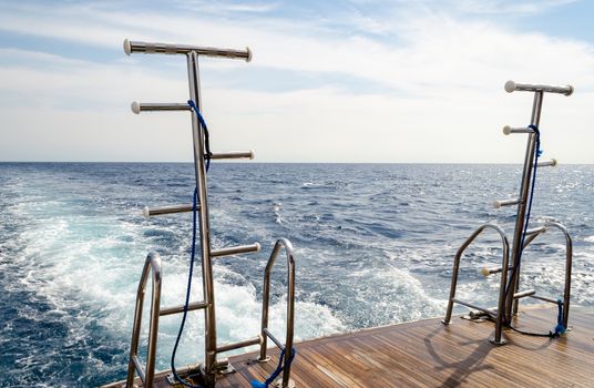 feed boats with raised ladders against the blue water of the Red Sea Egypt