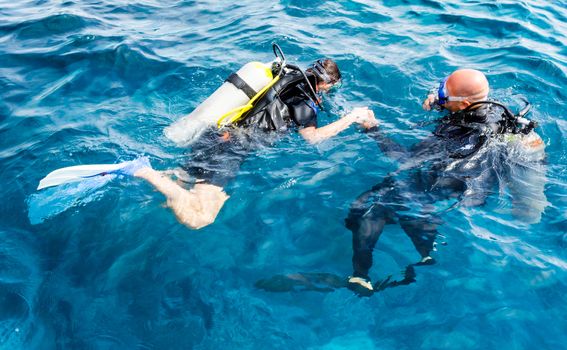 diver instructor teaches a beginner diver to dive in Egypt