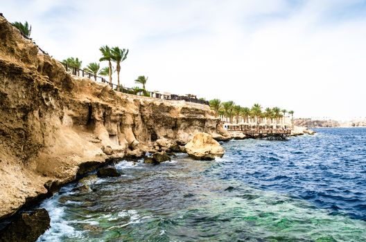 View from the sea to a rocky beach and a reef on the Red Sea coast