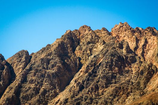 peaks of high rocky mountains against a blue sky in Egypt