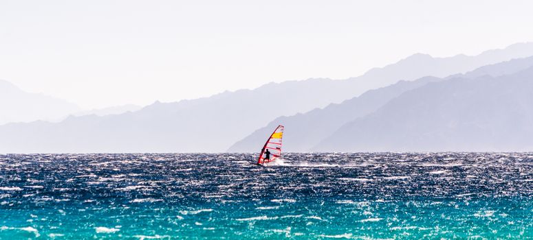 windsurfer rides on a background of high mountains in Egypt Dahab South Sinai
