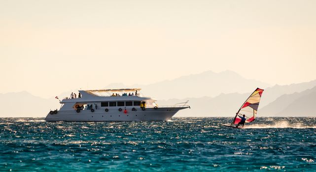 big boat and windsurfer on the background of high mountains in Egypt Dahab