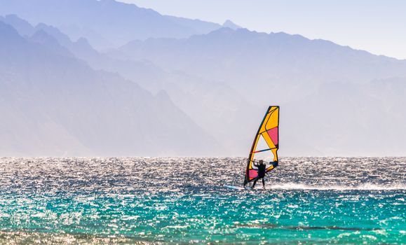 windsurfer rides on a background of high mountains in Egypt Dahab