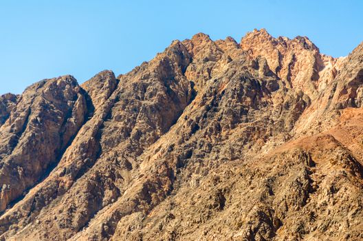 peaks of high rocky mountains against a blue sky in Egypt