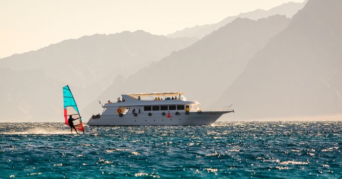big boat and windsurfer on the background of high mountains in Egypt Dahab