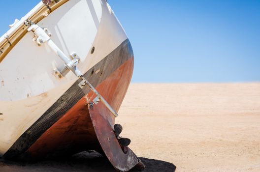 old broken yacht lay on the sand in the desert in Egypt