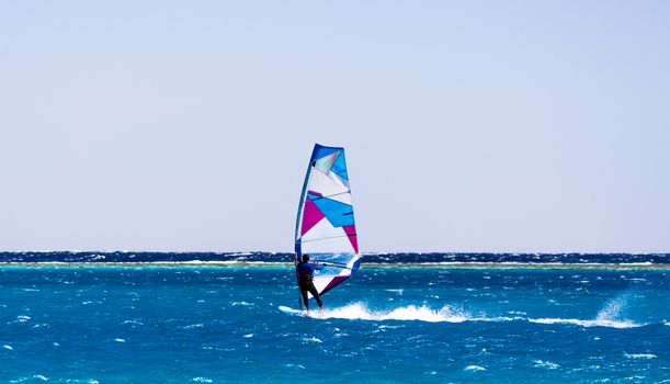 windsurfer rides on the waves of the Red Sea in Egypt Dahab