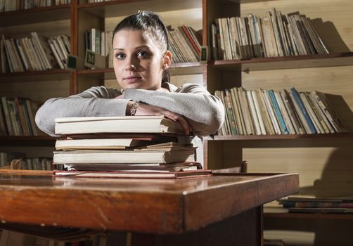 Student girl in a library. Looking at book