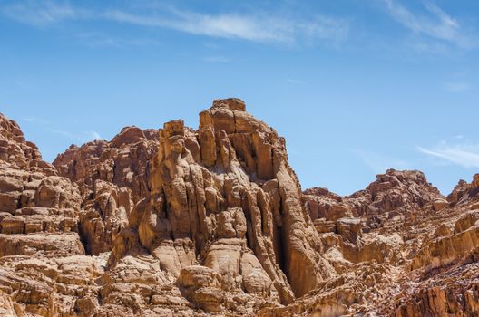 high rocky mountains against a blue sky and white clouds in Egypt Dahab