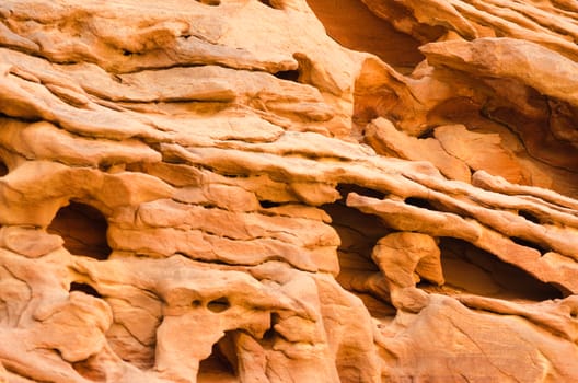 texture of orange stone rock in a colored canyon closeup