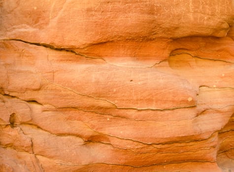 texture of orange stone rock in a colored canyon closeup