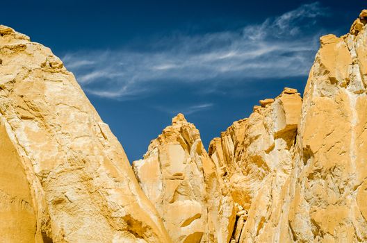 high rocky mountains against the blue sky and white clouds in the desert in Egypt Dahab South Sinai