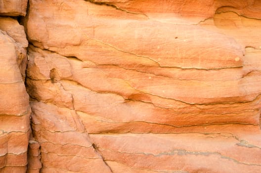 texture of orange stone rock in a colored canyon closeup