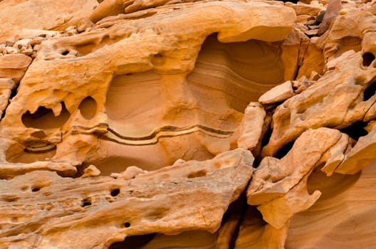 texture of orange stone rock in a colored canyon closeup
