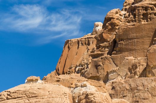 high rocky mountains in the desert against the blue sky and white clouds in Egypt Dahab