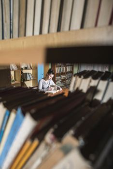 Student girl in a library. Looking at book